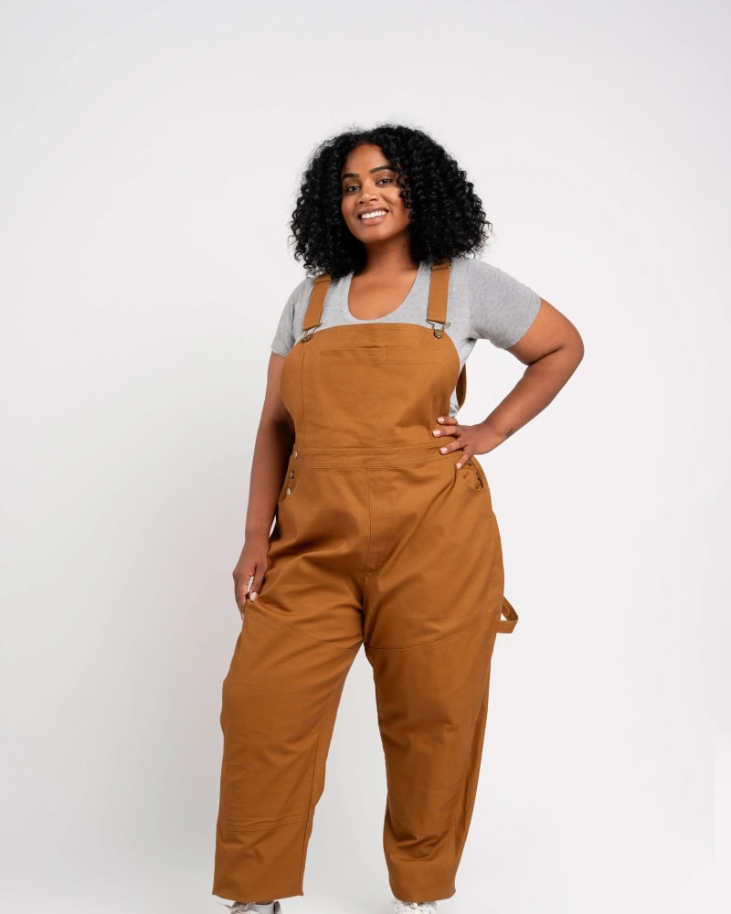 Front of a model wearing a size XL get dirty workwear overall in walnut by alder apparel. | dia_product_style_image_id:318949